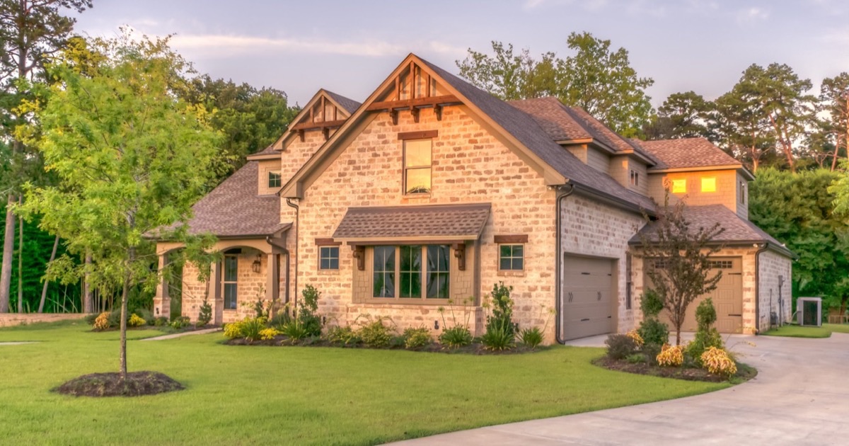 Carpenter's tools and rolled blueprints on a rustic workbench in natural light