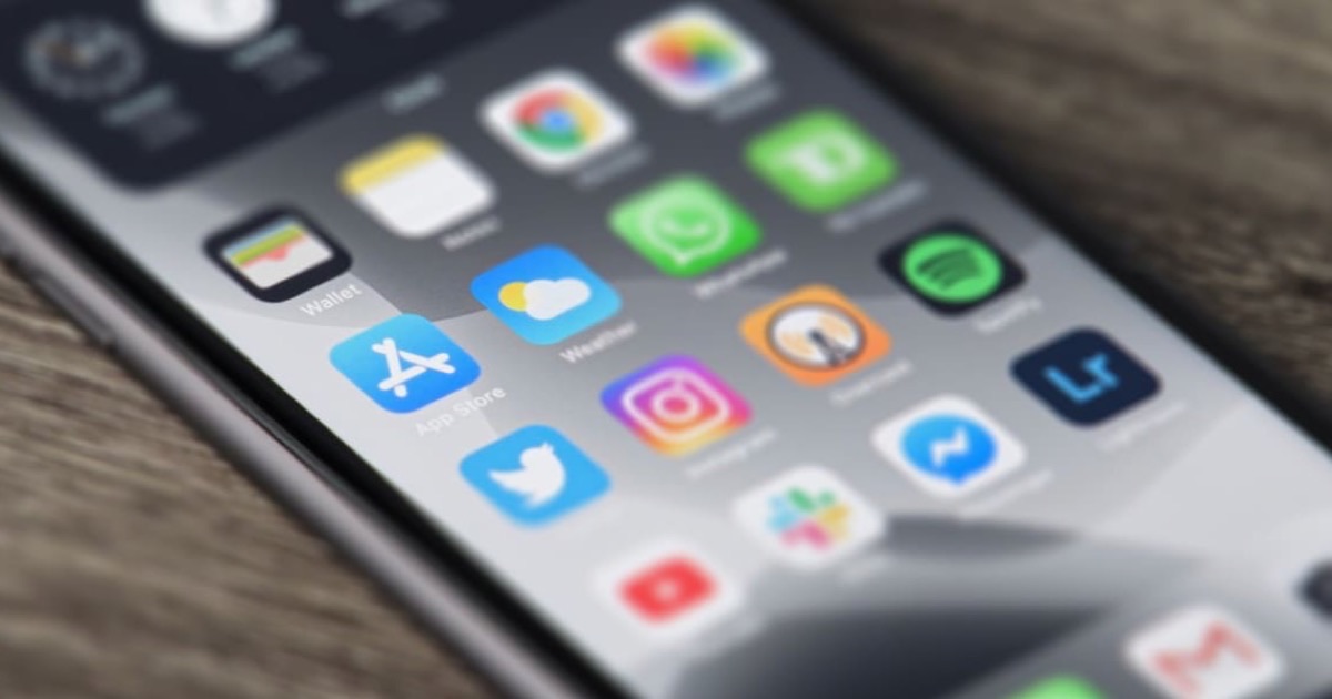 Sleek smartphone with white wireless earbuds case and a matte credit card on a clean white surface