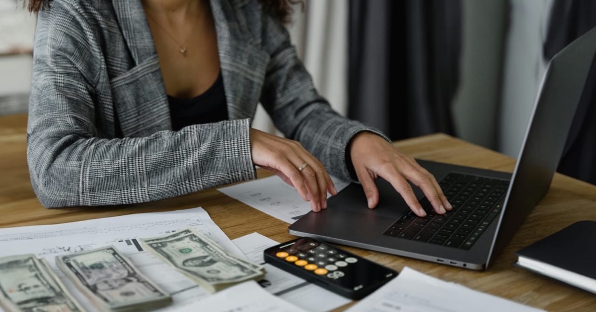 Two people reviewing a printed financial planning document together at a table