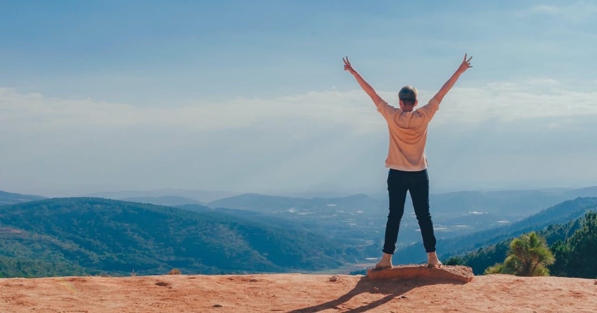 Person planning financial goals with a notebook and savings chart at a clean desk