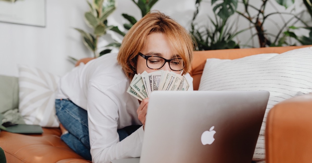 Person setting up automatic payments on a laptop with a planner open beside them