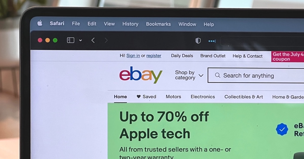 Person reviewing an eBay order confirmation on a smartphone at a desk