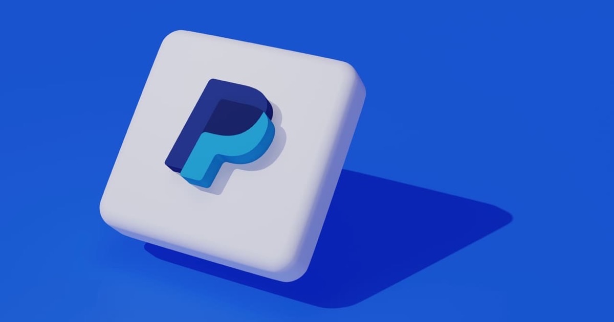 Person printing a PayPal payment receipt at a clean modern home office desk