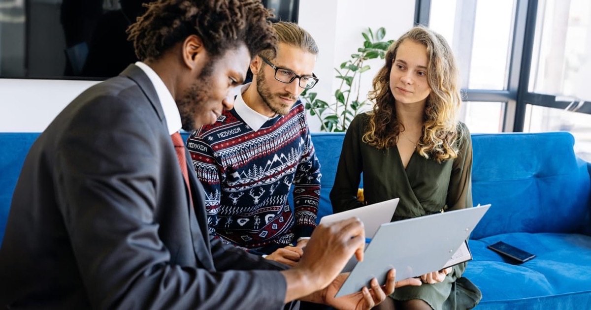 Two professionals reviewing a financial planning document together at a sunlit table
