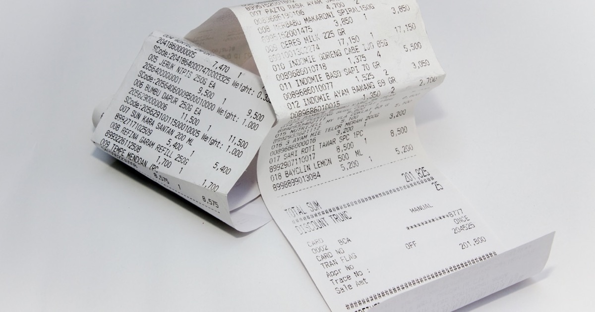 Organized receipt filing system with sorted folders and labeled documents for small business use